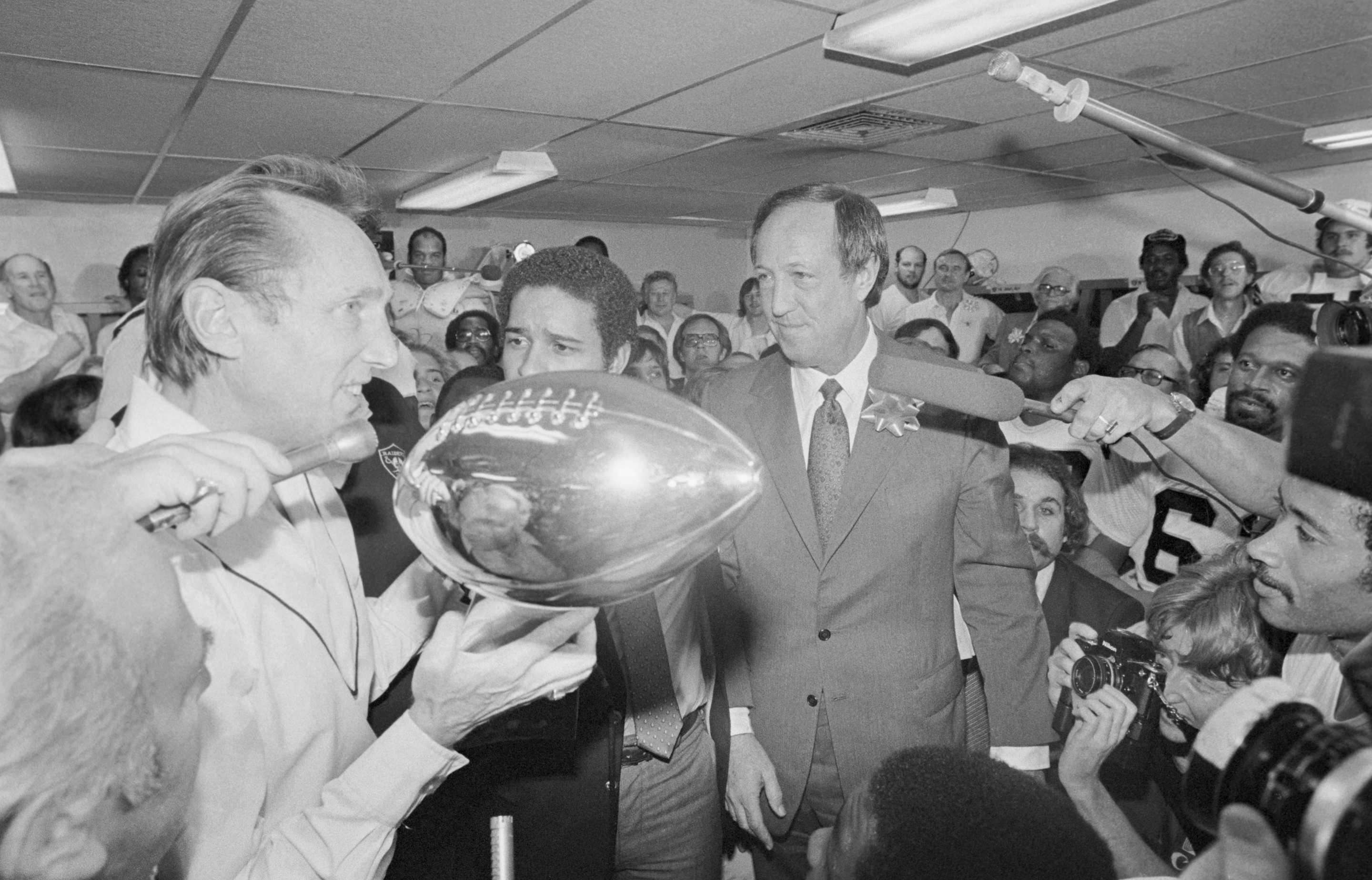 (Original Caption) New Orleans, Louisiana: Oakland Raiders managing partner Al Davis (left) accepts the Super Bowl trophy from the NFL commissioner Pete Rozelle following the Raiders' 27-10 victory. Davis and the commissioner have been feuding over Davis' attempt to move the club from Oakland.