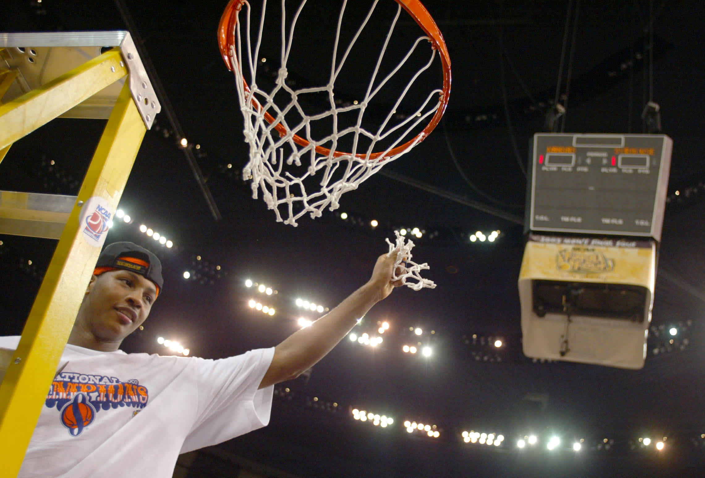 NEW ORLEANS - APRIL 7: Carmelo Anthony #15 of Syracuse cuts down the net after he and his team defeated Kansas 81-78 during the championship game of the NCAA Men's Final Four Tournament on April 7, 2003 at the Louisiana Superdome in New Orleans, Louisiana. Anthony was named the tournaments most outstanding player. (Photo by Craig Jones/Getty Images)