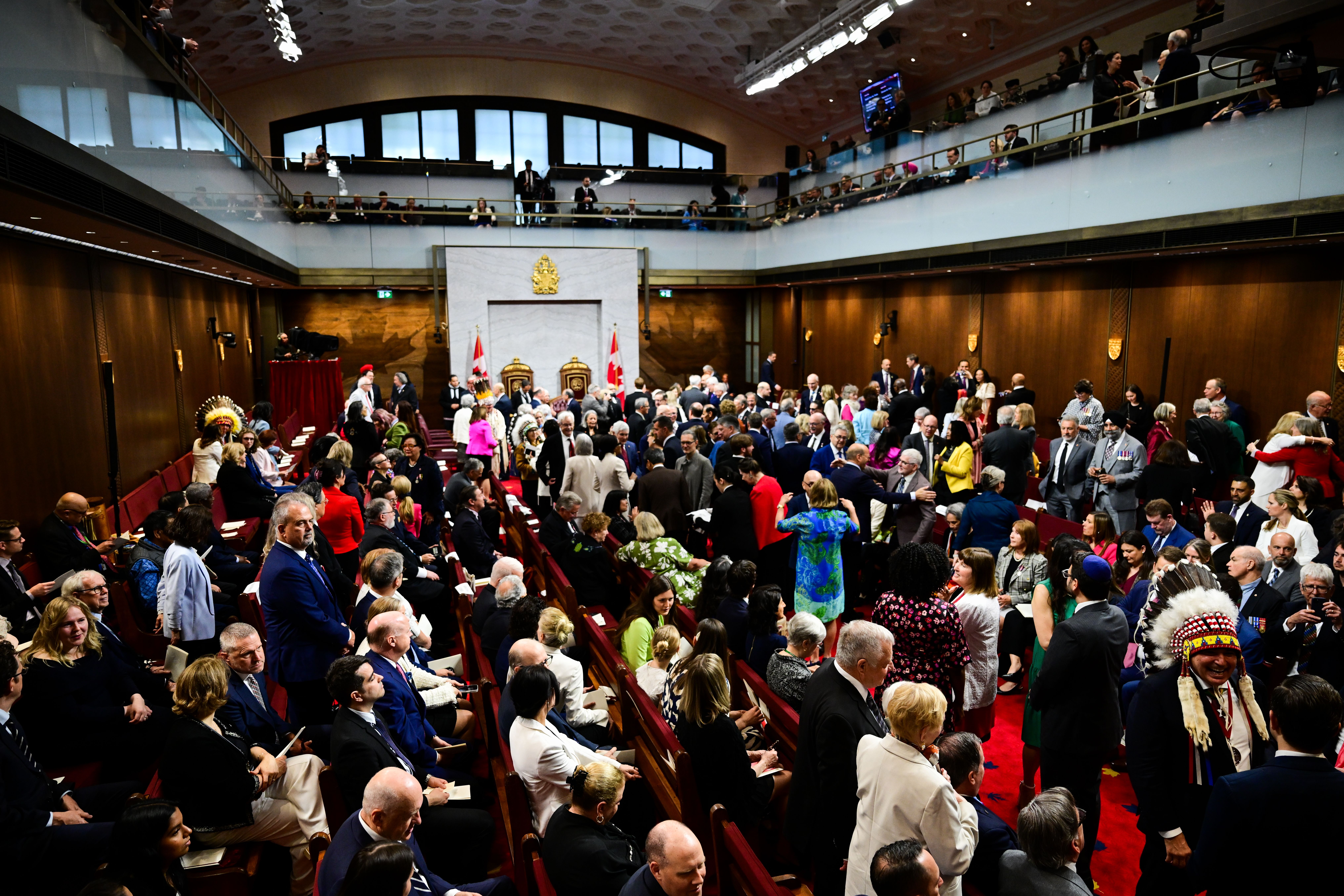 eople gather before Britain's King Charles III delivers a speech